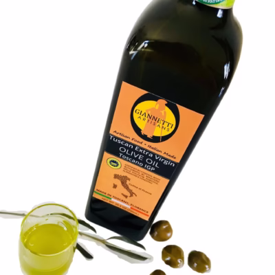 Certified olive oil by Giannetti Artisans poured from a 25 oz bottle into a glass.
