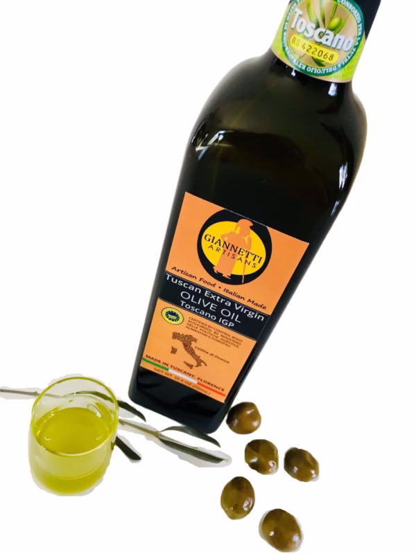 Certified olive oil by Giannetti Artisans poured from a 25 oz bottle into a glass.
