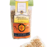A 1lb bag of Giannetti Artisans pearled italian farro with farro grains next to the bag on a white background