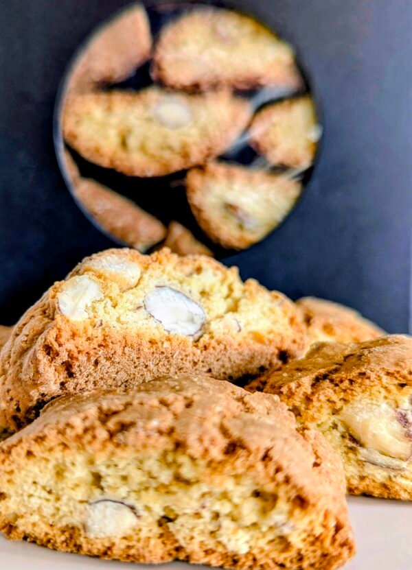 Close up of Giannetti Artisans Almond Biscotti with black packaging in background