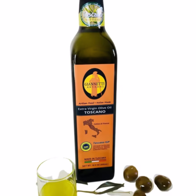Italian olive oil from Tuscany by Giannetti Artisans in a 16.9 oz bottle next to a glass of oil and olives.