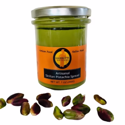 One 7 oz jar of Giannetti Artisans Sicilian Pistachio Spread with pistachios in front of the jar on a white background