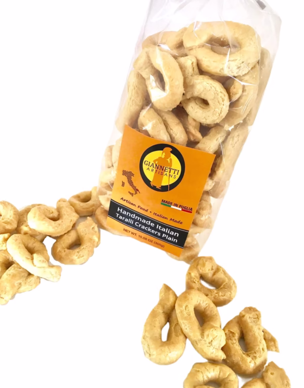 Top view of a bag of Giannetti Artisans plain Italian taralli crackers on a white background