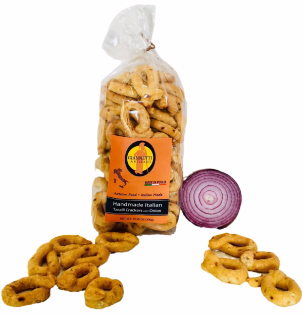 Far view of bag of Giannetti Artisans handmade onion taralli with loose crackers on a white background