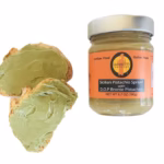 Giannetti Artisans Sicilian Pistachio Cream Spread made with certified Bronte DOP pistachios, shown with a jar and two spoonfuls of smooth green nut spread.