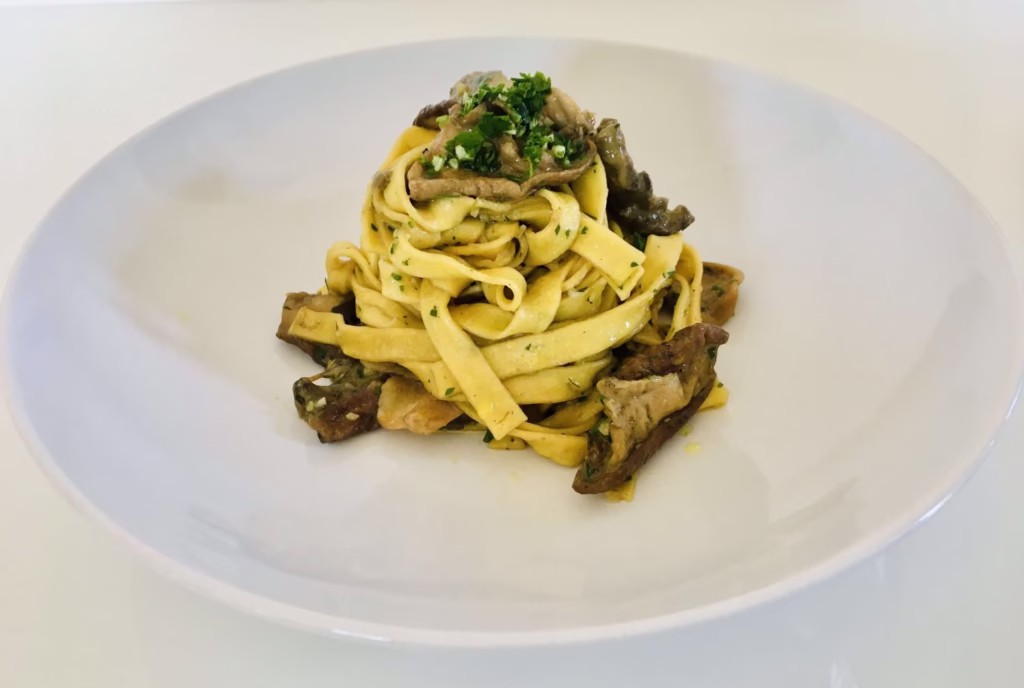 A plate of pasta with mushrooms for Giannetti Artisans Tagliatelle Pasta Recipe with Italian Porcini Mushrooms