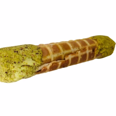 Close-up of a crisp Italian cannoli wafer roll filled with rich pistachio cream filling
