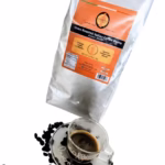 Close up of one bag of Giannetti Artisans Italian Espresso Coffee Beans with an espresso cup prop on white background