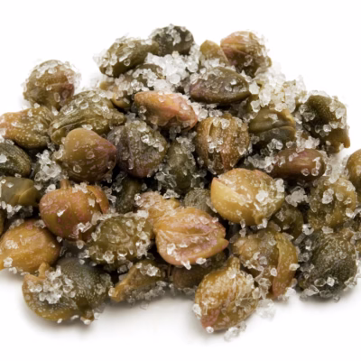 Close up of salted capers on white background for Giannetti Artisans Artisan Spices Collection