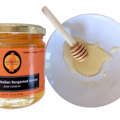 250 g jar of Giannetti Artisans Italian Honeysuckle Honey with Bergamot Essence and wooden honey stick