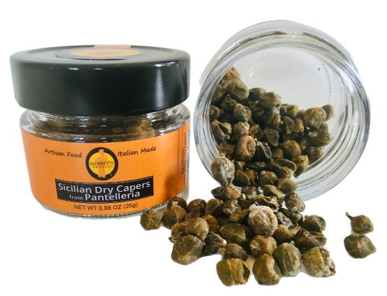 Giannetti Artisans Dry Capers Close Up A close up of a jar of Giannetti Artisans Sicilian Dry capers with another jar that displays the actual dried capers pouring out