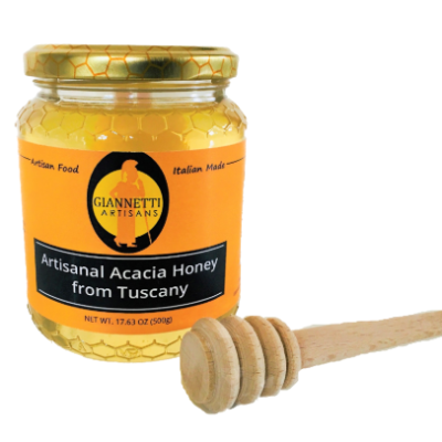 A 17.63 oz jar of Giannetti Artisans Italian Acacia Honey on a white backgorund with wooden honey dipper on the side